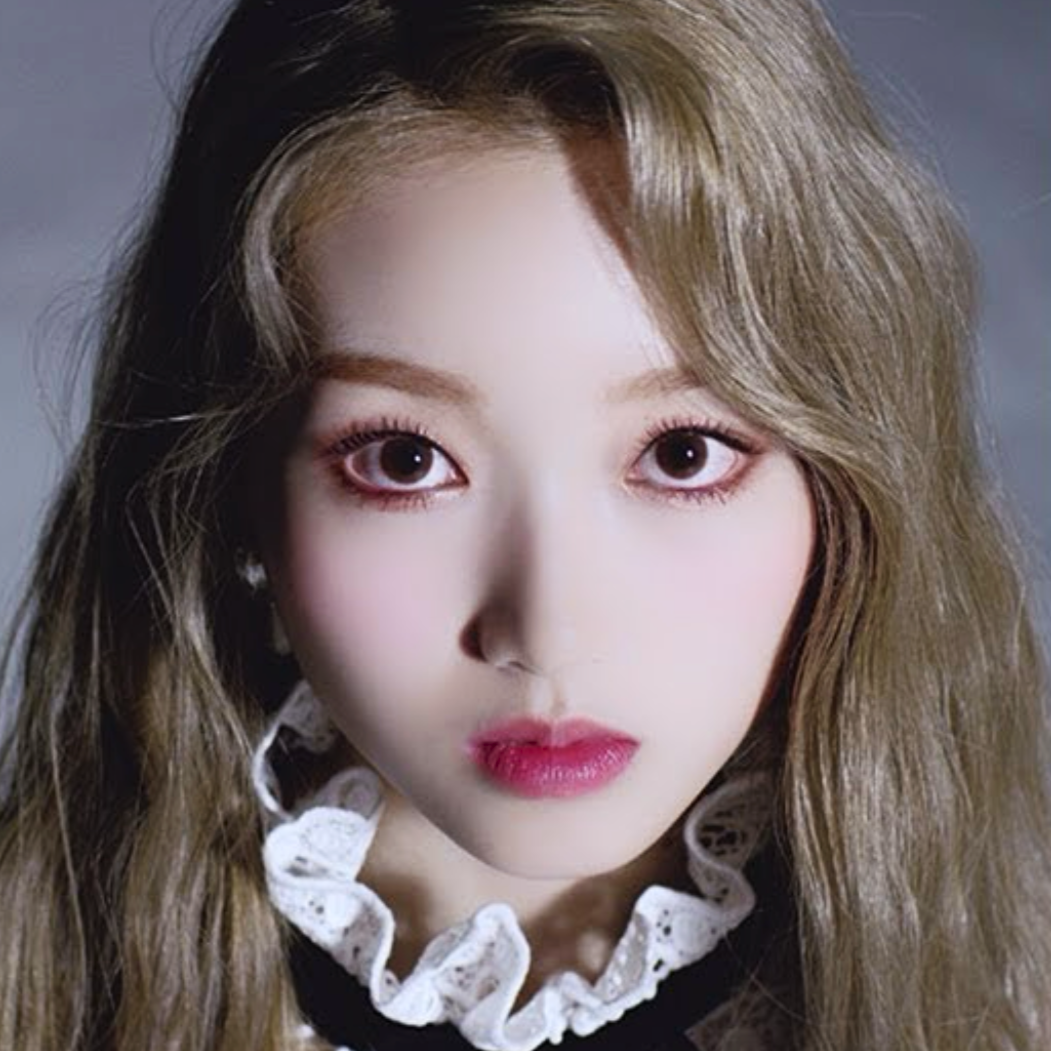 Go Won from the 'One and Only' music video. She has long blonde hair and is wearing a frilly outfit. She is staring at the viewer intensely.